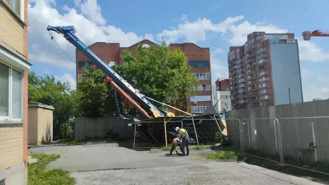Кран для забивки свай накренилась и свалилась на навес парковки дома на Каслинской, повредив автомобиль. Застройщик объясняет инцидент просадкой грунта, угроз для соседних домов нет.